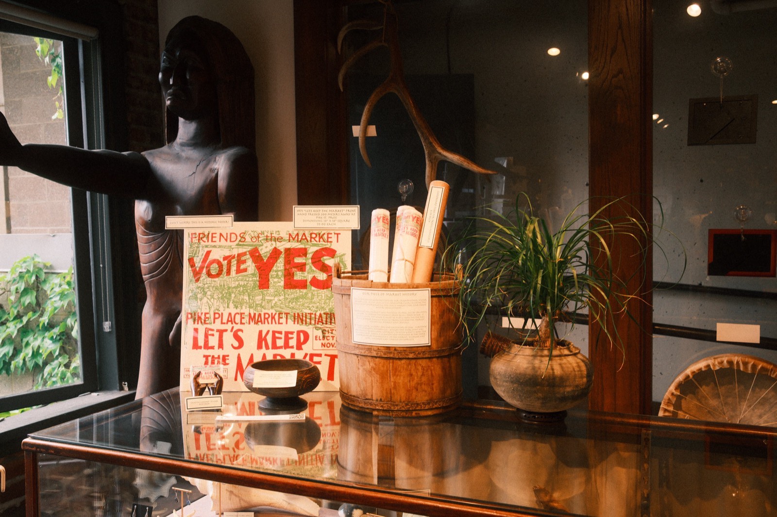A vintage 'Vote Yes — Let's Keep the Market' sign on display at The Raven's Nest, from the 1971 campaign that saved Pike Place Market