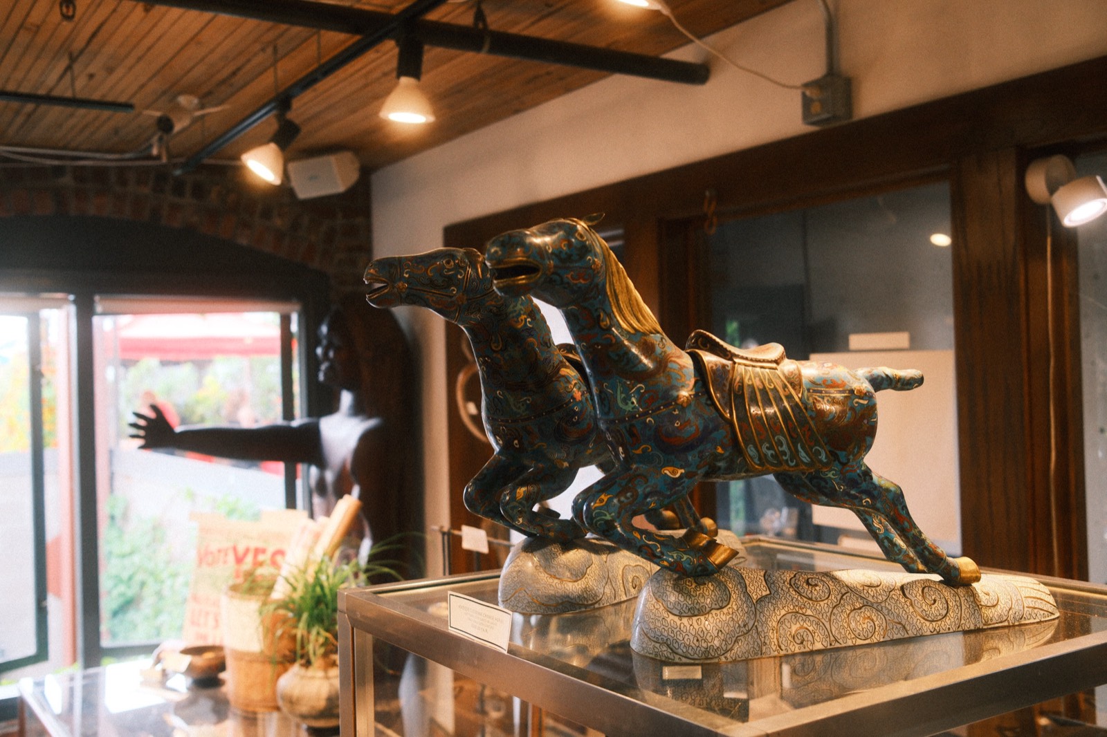 A bronze raven sculpture among the treasures at The Raven's Nest